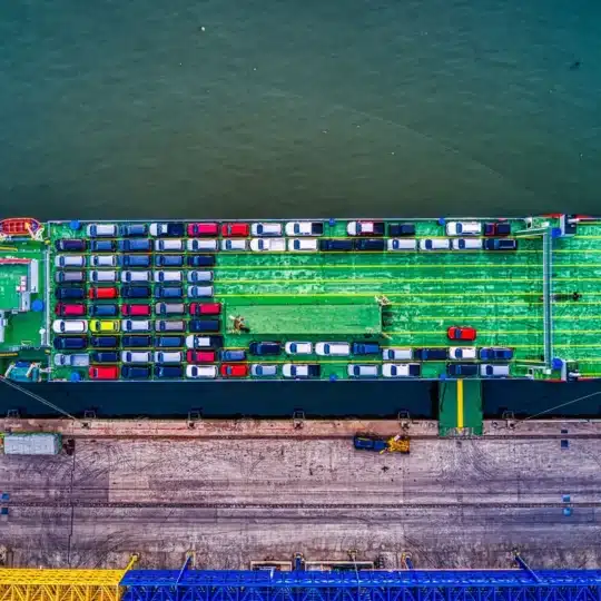 Aerial view of a car transport ship docked at Bekasi port, Indonesia.