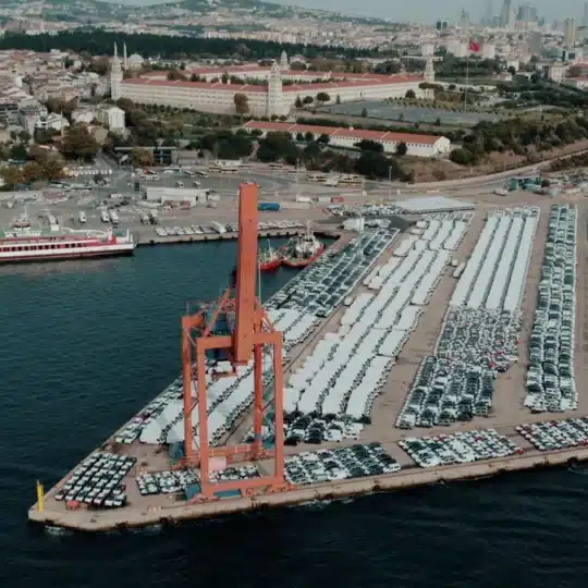 Aerial view of a bustling car shipping terminal in Istanbul, Türkiye, showcasing a busy port with ve
